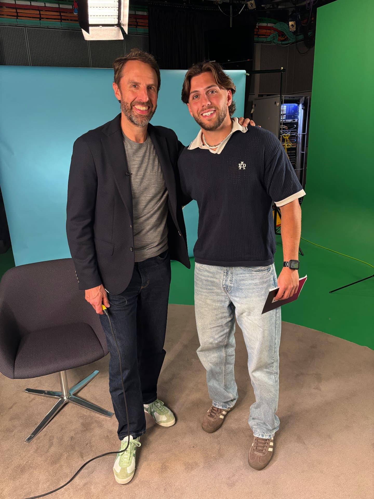 Luke Alfano with a guest at a television studio